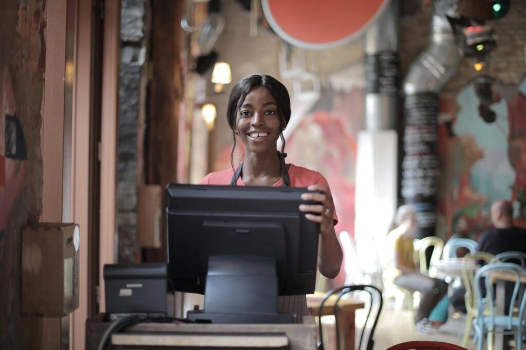 A front-of-house waitress smiling