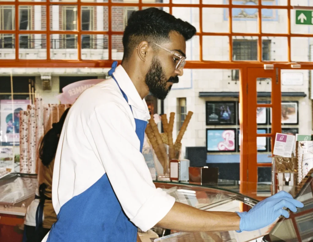Employee serving a customer over the counter