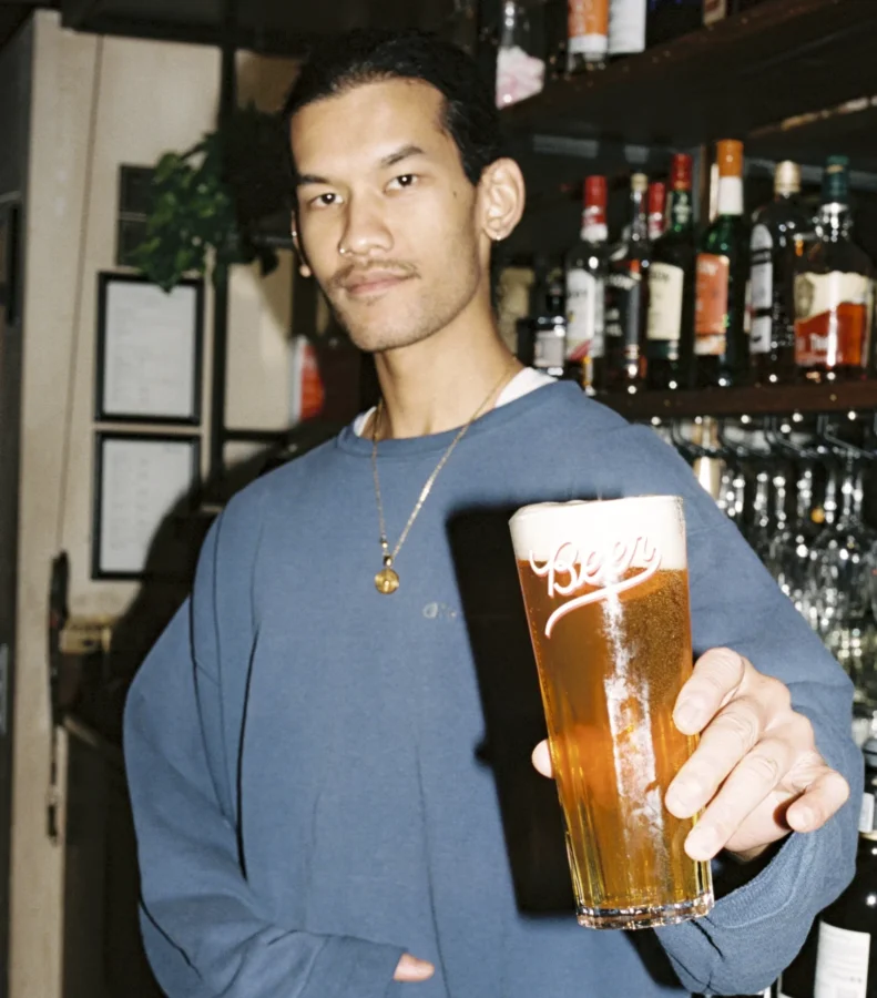 Staff serving pint in a pub