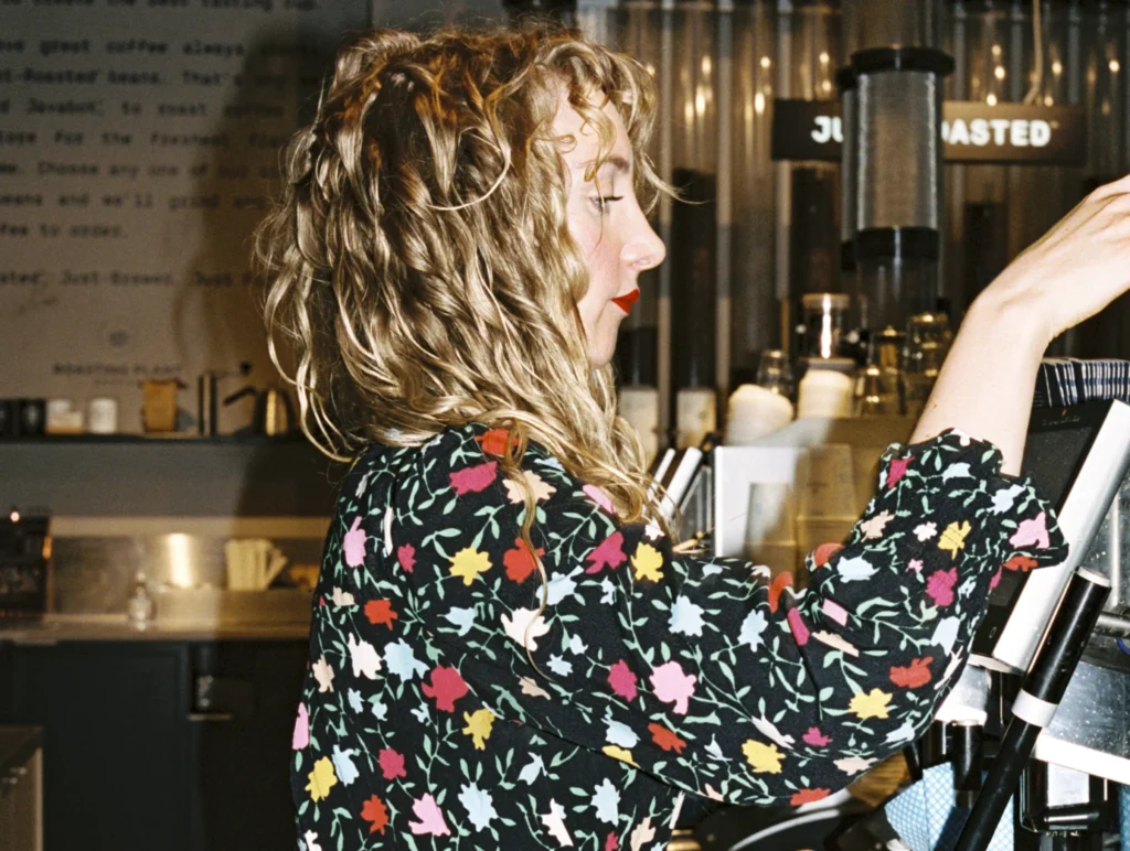 A barista preparing coffee in a cafe