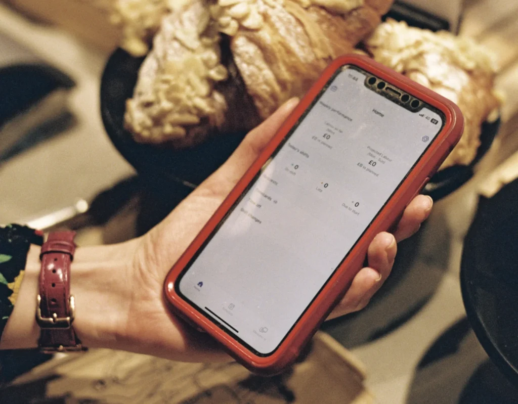 Coffee shop owner using Nory mobile app to track sales