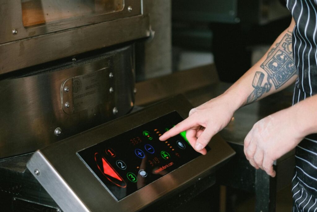 Chef operating a large oven