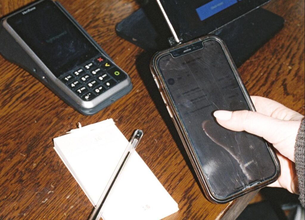 User holding mobile phone while using the Nory mobile app