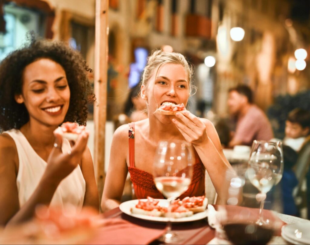 Two friends eating dinner at a restaurant