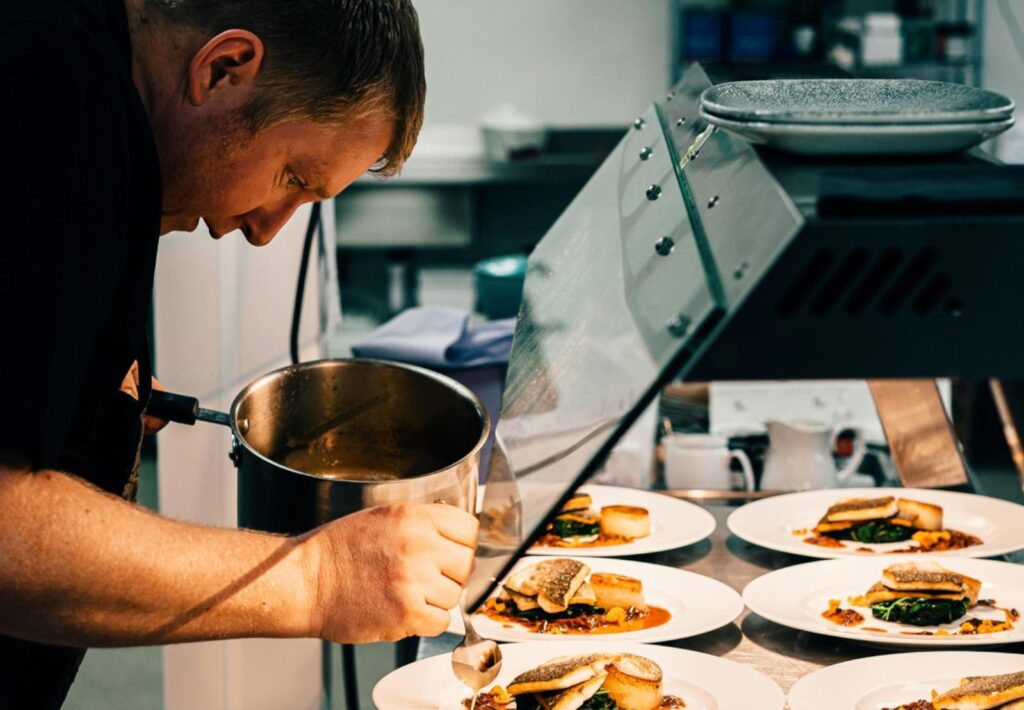 A chef carefully plating food