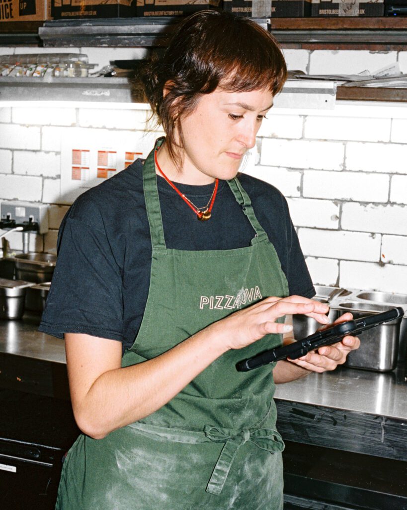 Restaurant employee using Nory's app on a tablet